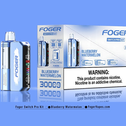 Foger Switch Pro Kit Blueberry Watermelon flavor displayed in vibrant blue packaging, highlighting features like Norm and Boost modes for 30,000 or 18,000 puffs, dual mesh coil technology, OLED smart screen display, and a combined disposable vape and power bank functionality. The kit showcases a clear airflow tank with 5% nicotine and detailed product packaging with a prominent nicotine warning.