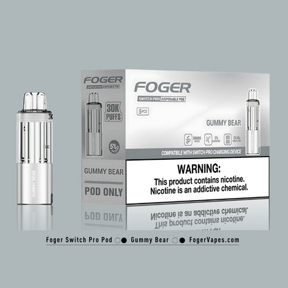 Foger Switch Pro Gummy Bear Disposable Pod 5-Pack High-capacity vape pods offering 30,000 puffs each with 5% nicotine strength. The sleek silver packaging emphasizes the sweet and nostalgic gummy bear flavor, perfect for candy enthusiasts. Designed with dual mesh coil technology, adjustable airflow, and compatibility with the Switch Pro charging device, this product ensures a long-lasting and fun vaping experience.