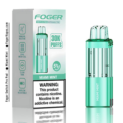 Foger Switch Pro Miami Mint Disposable Pod High-Capacity Vape Device Offering 30,000 Puffs with 5% Nicotine Strength. Featuring a sleek, transparent green design with dual mesh coil technology and adjustable airflow. The Miami Mint flavor combines a refreshing minty coolness, delivering a smooth vaping experience. Compact packaging emphasizes premium quality and user convenience.